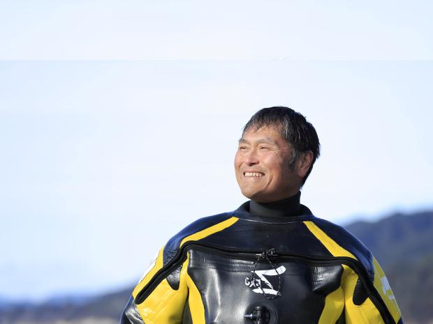 PADI AmbassaDiver Hiroshi Sato in his wet suit.